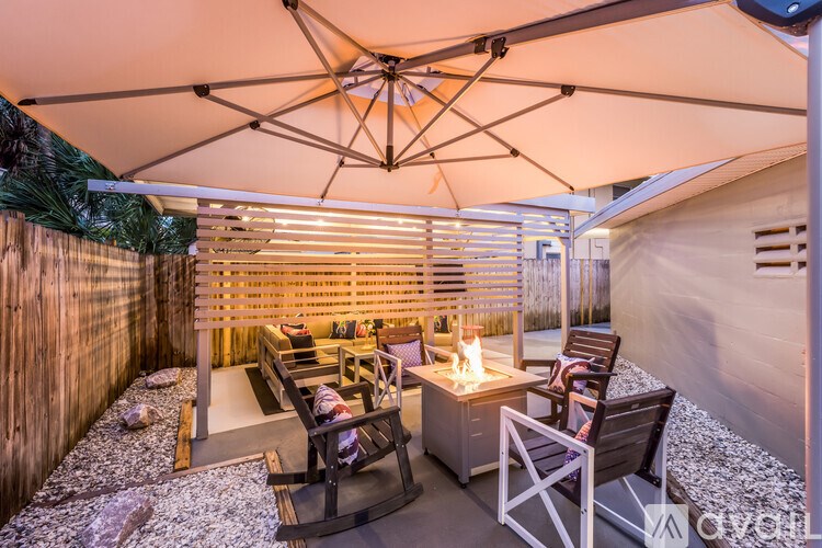 A patio with a table and chairs under a canopy.
