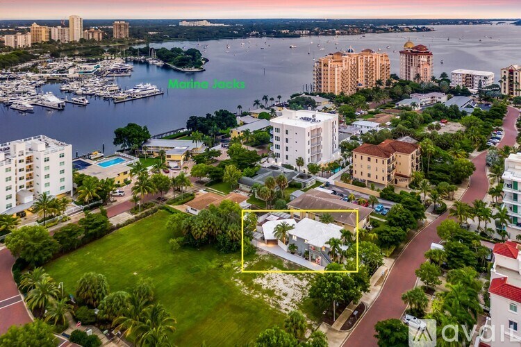 A bird's eye view of a residential area with a house in the foreground.