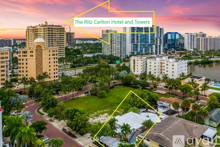 The Ritz Carlton Hotel and Towers is a large hotel complex with a swimming pool and green spaces.