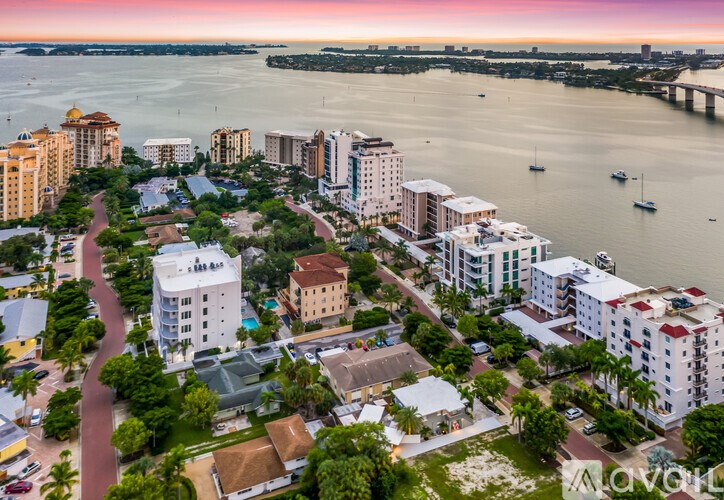 A cityscape with buildings and a body of water.
