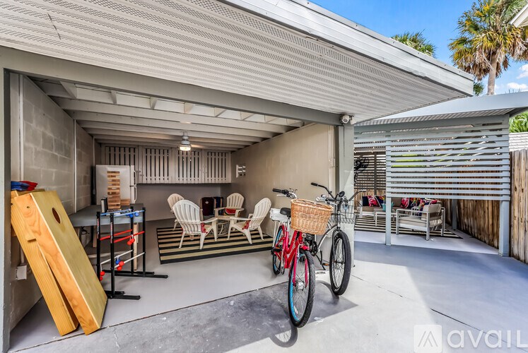 A bicycle is parked in a garage with a red basket.