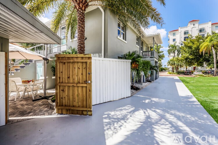 A white house with a wooden gate in front of it.