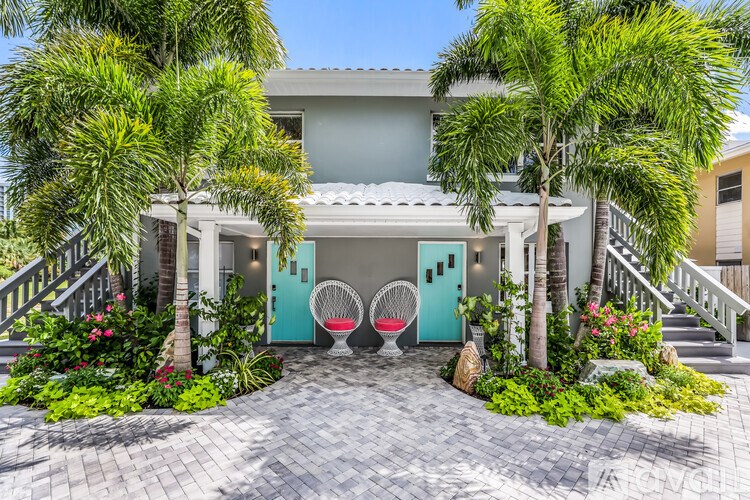 A white house with a blue door and a small porch.