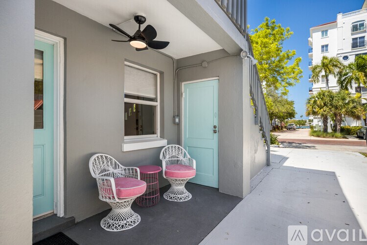 A patio with two chairs and a table.