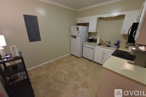 A kitchen with a table and chairs in it.