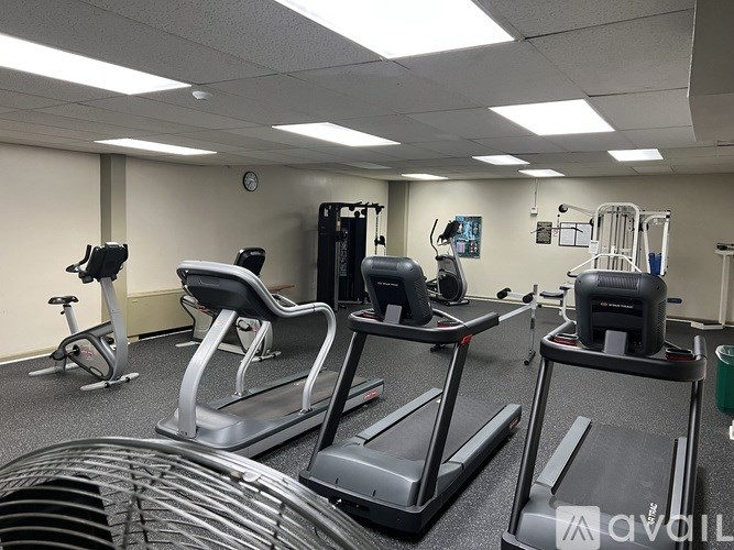 A gym with treadmills, elliptical machines, and other exercise equipment.