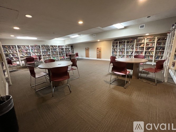 A library with tables and chairs and bookshelves.