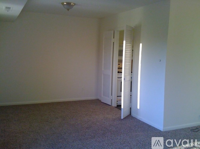 A room with carpeted floor and white walls.