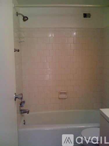 A bathroom with a tub and a shower.