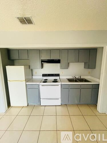 A kitchen with white appliances and a white refrigerator.