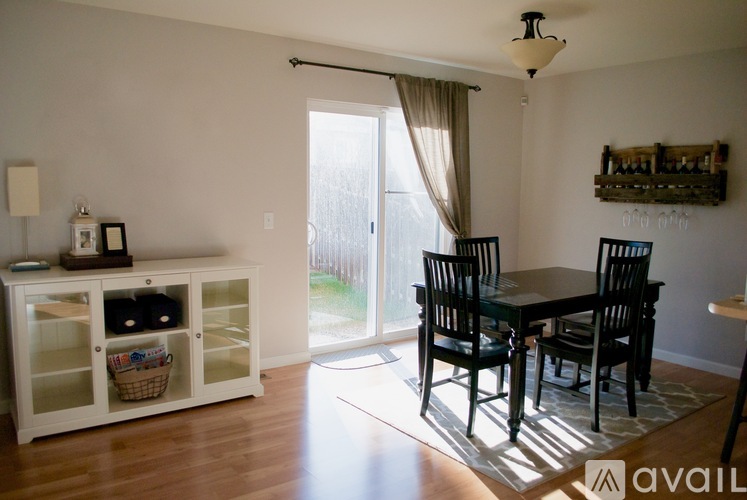 A dining room with a table and chairs.