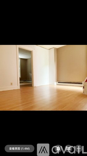 A room with wooden floors and a white door.