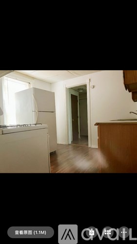 A kitchen with white appliances and wooden cabinets.