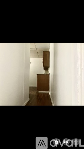 A brown box is on a white wall.