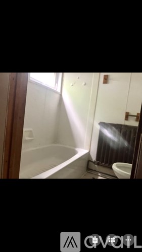 A bathroom with a toilet, sink, and bathtub.