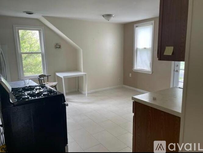 A kitchen with a black stove top oven and a white counter top.