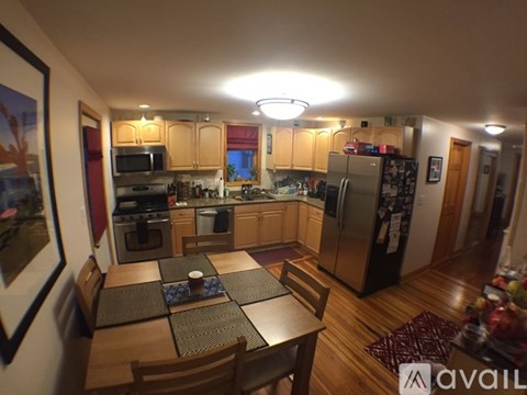 A kitchen with wooden cabinets and a table set for two.