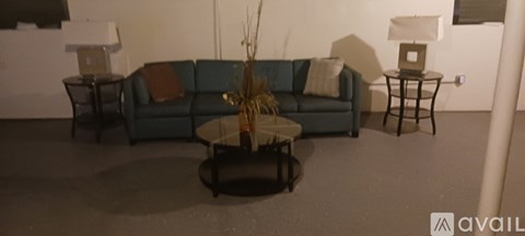 A living room with a blue couch and a coffee table.