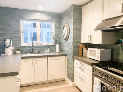 A kitchen with a white oven and cabinets.