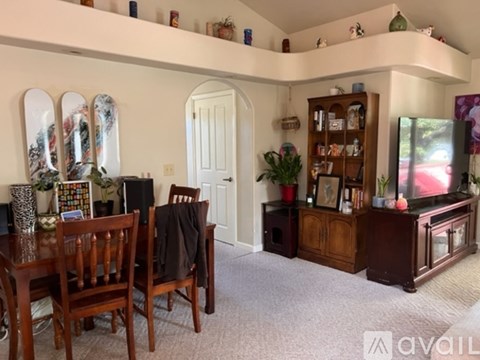 A living room with a wooden table and chairs.