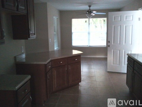 A kitchen with brown cabinets and a white door.