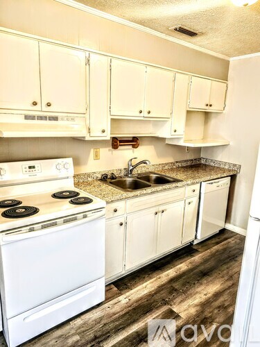 A kitchen with white appliances and cabinets.