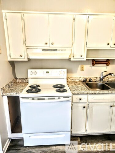 A white oven and sink in a kitchen.