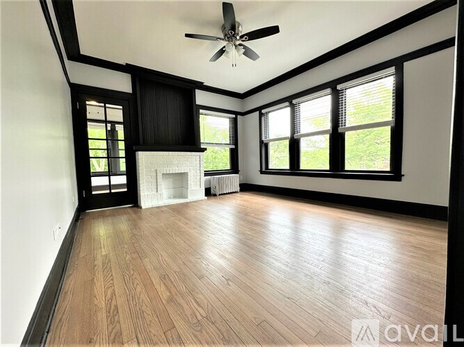 A room with wooden floors and a ceiling fan.
