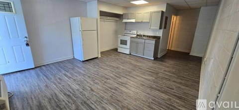 A kitchen area with a refrigerator, microwave, and oven.