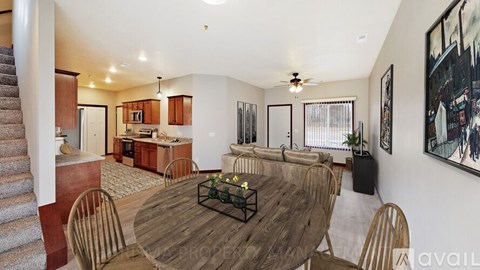 A dining room with a wooden table and chairs.