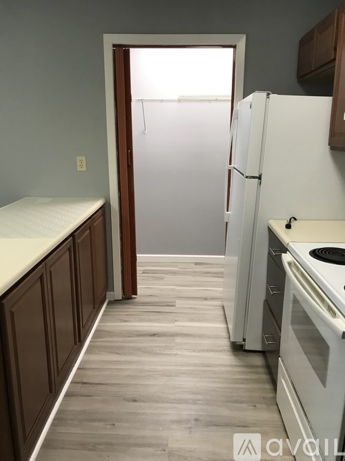 A kitchen with a white fridge and a white oven.