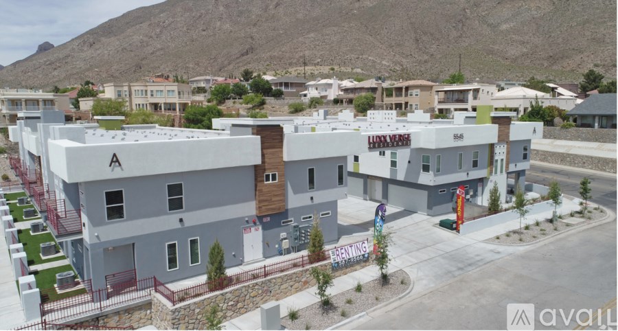 A modern building complex with a mountain in the background.