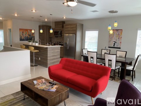 A red couch is in the middle of a modern living room.