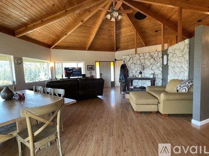 A living room with wooden floors and furniture.
