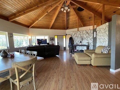 A living room with wooden floors and furniture.