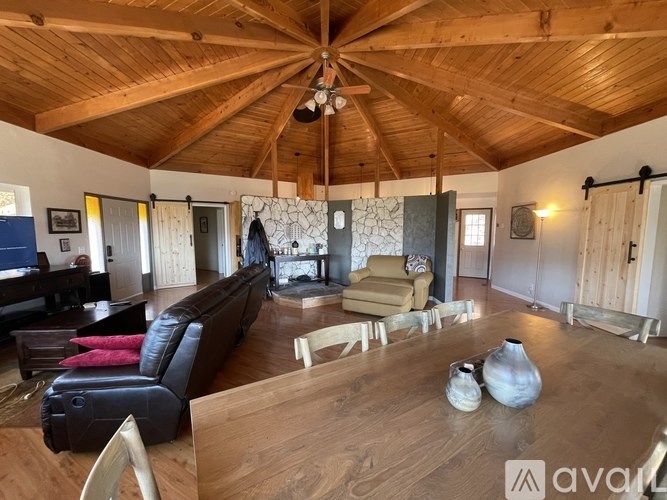 A living room with wooden floors and furniture.