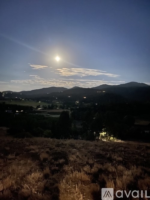 A sunrise or sunset scene with a mountain range in the background.