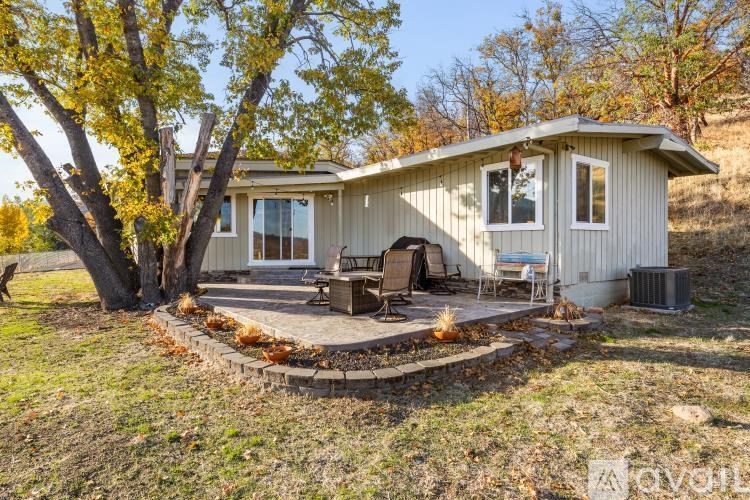 A house with a patio and a fire pit in the yard.