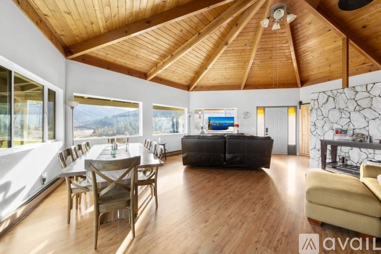 A spacious living room with wooden floors and furniture.