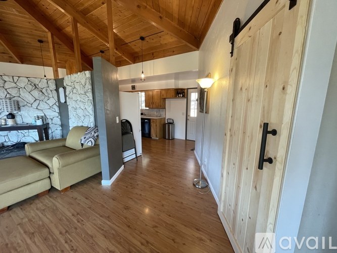 A living room with wooden floors and a couch.
