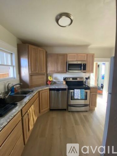 A kitchen with wooden cabinets and stainless steel appliances.
