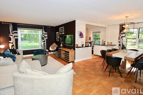 A modern living room with a white sofa and a wooden floor.
