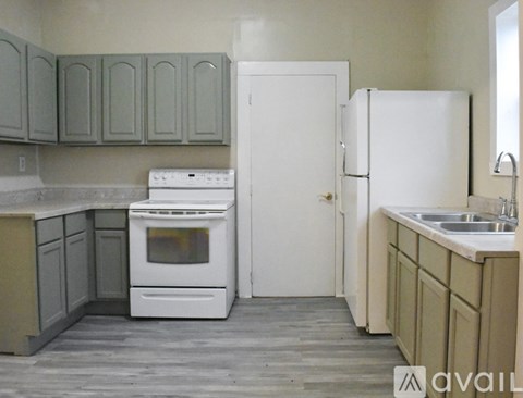 A kitchen with a white oven and sink.