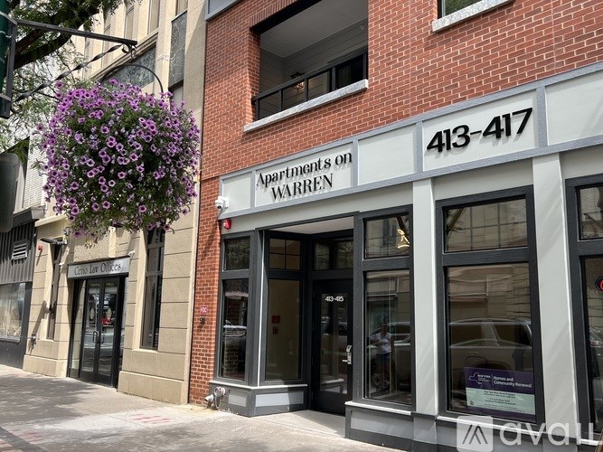 Apartments on Warren building with a hanging flower basket.