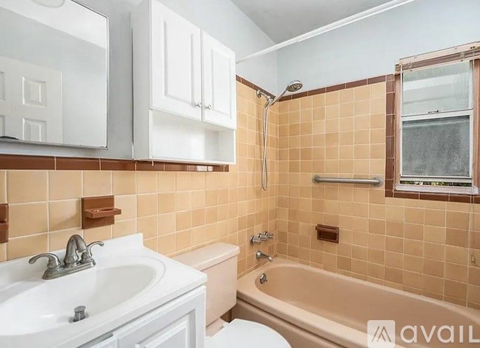 A bathroom with a toilet, sink, and bathtub.