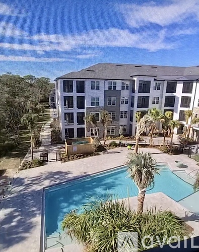 A large building with a pool in front of it.