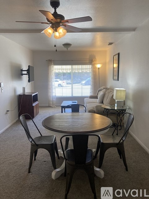 A living room with a round table and chairs.