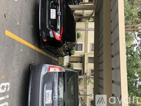 Two cars are parked in a parking lot.