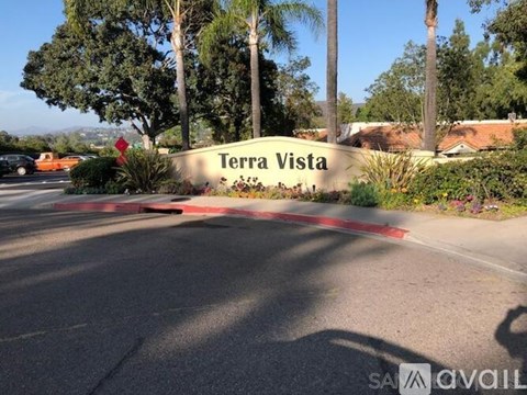 Terra Vista sign in front of a street with trees.