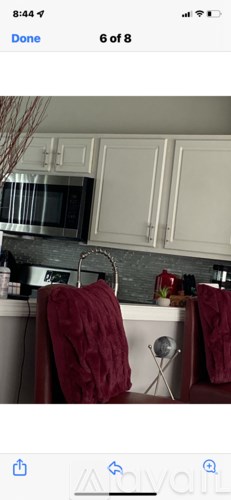 A kitchen with white cabinets and a microwave above the stove.